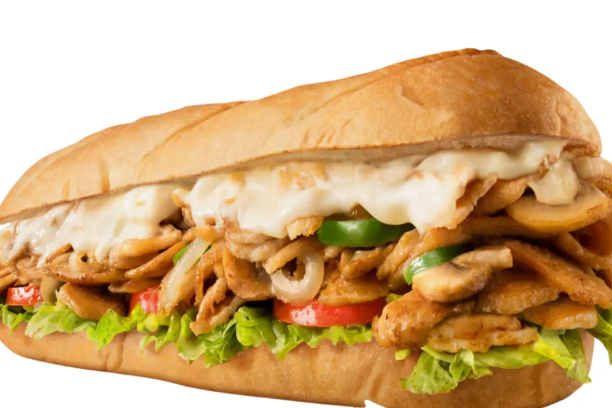 Chicken Philly Cheesesteak sandwich on a toasted hoagie roll with melted cheese, peppers, onions, and mushrooms.
