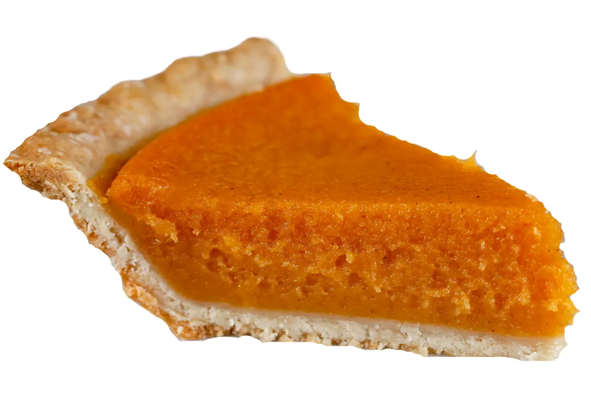 A freshly baked sweet potato pie with a golden-brown crust, sitting on a rustic wooden table adorned with autumn leaves