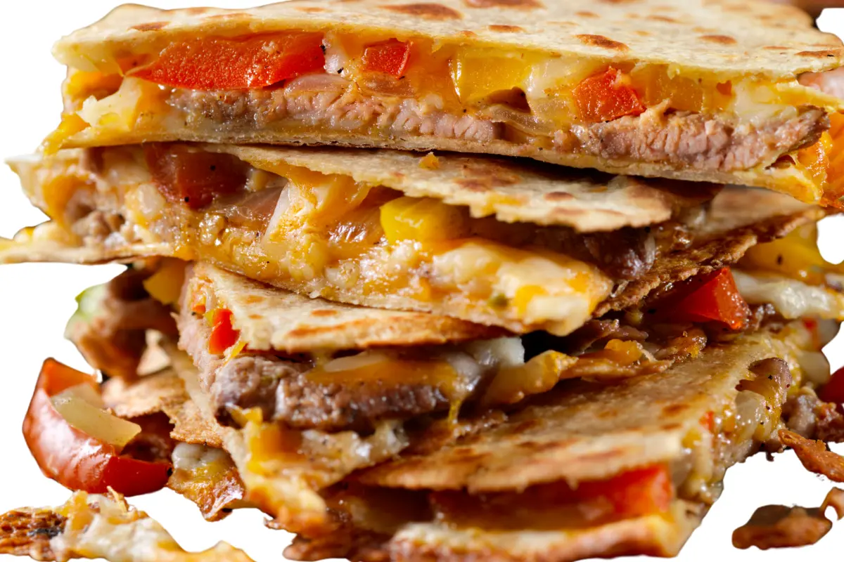 Steak quesadilla with cheese, tomatoes, onions, and cilantro.