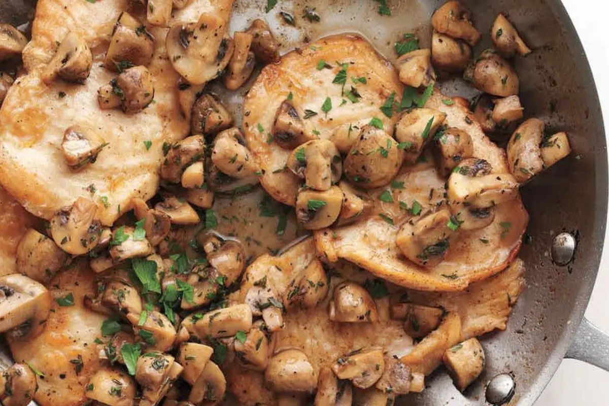 Skillet chicken dish topped with sautéed mushrooms and caramelized onions.